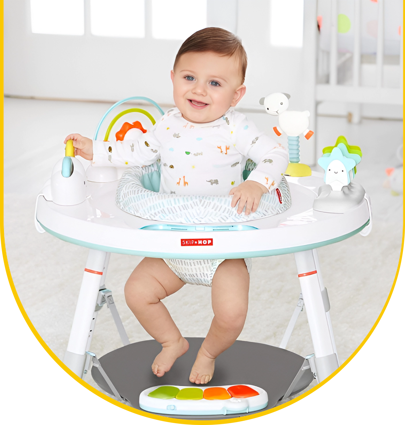 A baby sitting in a high chair with a rainbow on it.