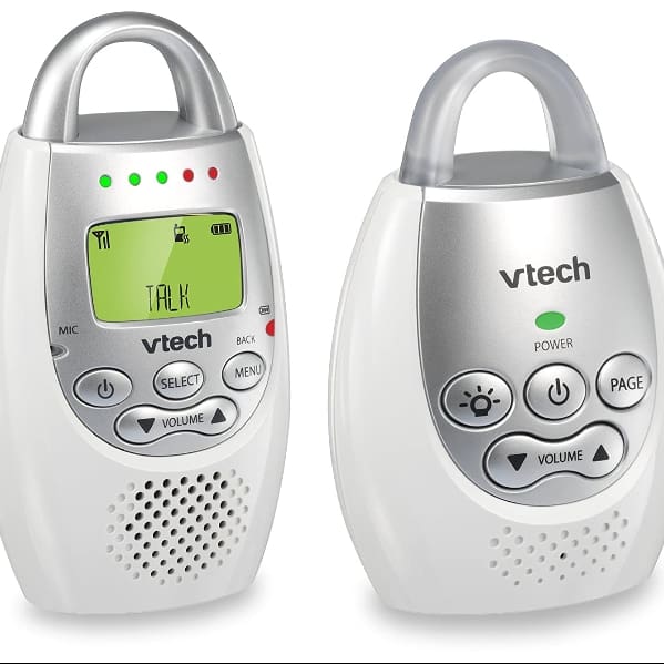 A white and silver baby monitor with a green screen.