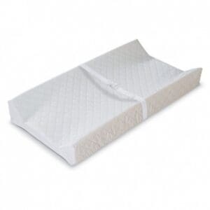 A white changing pad with a folded up cover.