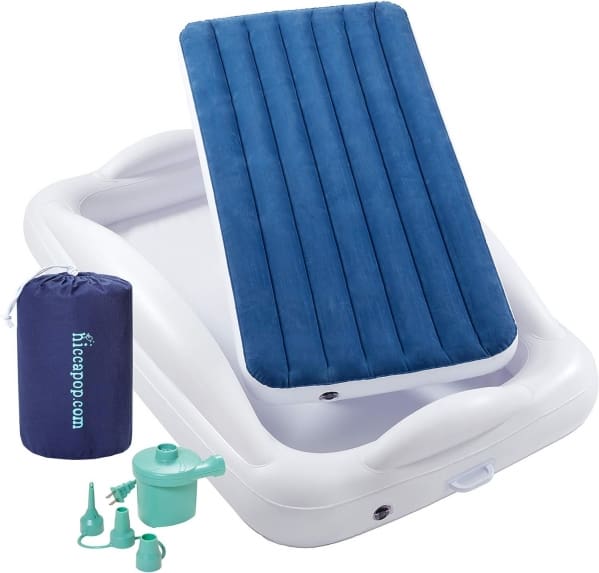 A white tray with blue mattress and pillow.