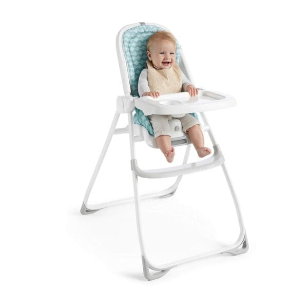 A baby in a high chair with a blue seat.