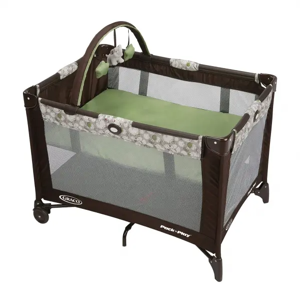 A baby crib with wheels and a green cover.