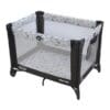 A black and white baby crib with a blue star print.