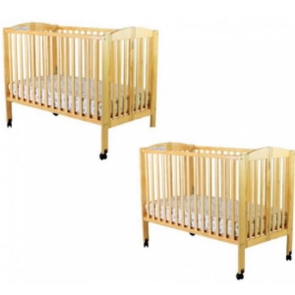 A pair of wooden cribs with wheels and covers.