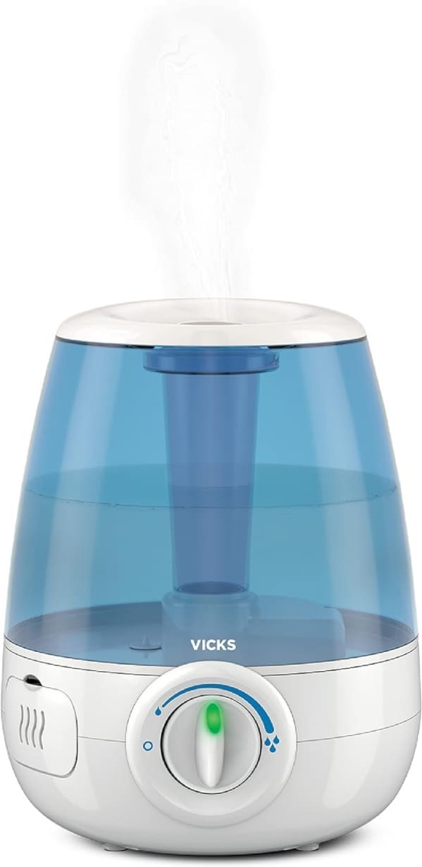 A blue and white humidifier is sitting on the floor.